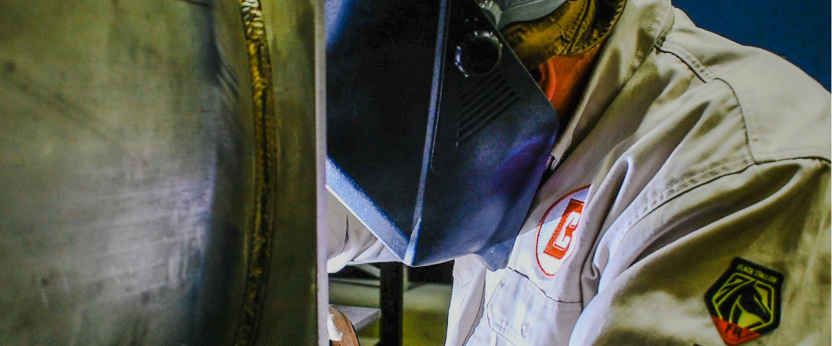 Welder performing certified repairs on Blentech stainless steel equipment to support uptime and long-term performance.